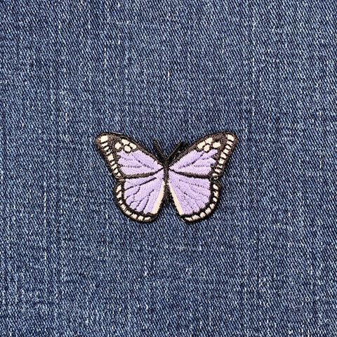 Lilac purple butterfly patch on denim fabric