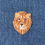 Embroidered lion patch on a denim background