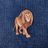 Embroidered lion patch on denim fabric