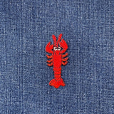 Red lobster patch on blue denim fabric