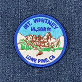 Embroidered patch of Mount Whitney on a denim background