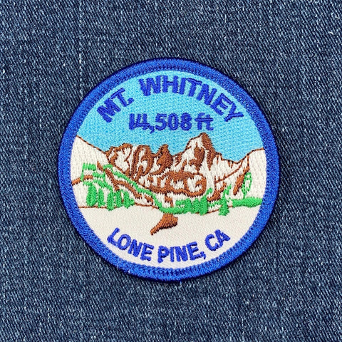 Embroidered patch of Mount Whitney on a denim background