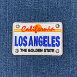 Embroidered patch of a California license plate on denim fabric