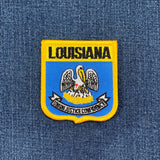 Louisiana state emblem patch on a denim background