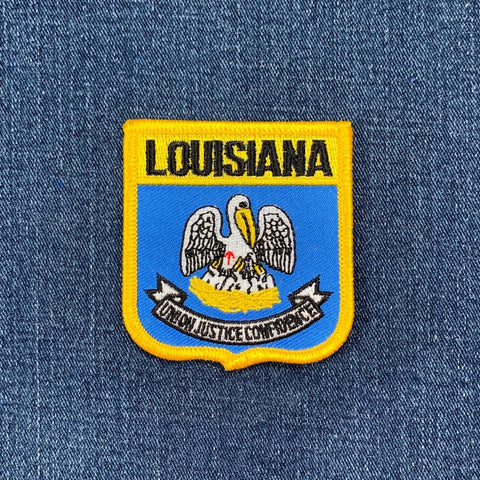Louisiana state emblem patch on a denim background