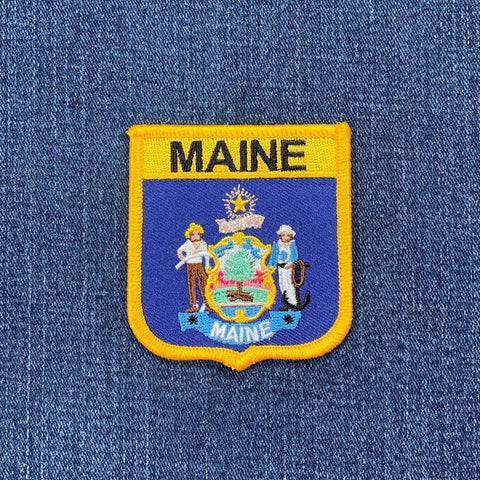 Maine state patch on a denim background