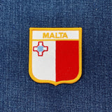 Malta flag patch on a denim background
