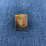 A pin with a graphic design depicting Mammoth Cave National Park on a denim background