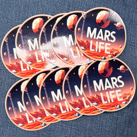 Ten 'Mars Life' stickers on a denim surface