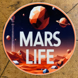 A circular sticker featuring an abstract, low-poly depiction of a scene on Mars with orange hills, space habitats, and a large windmill. A geometric planet hangs in the dark sky. Large white text in the center reads 'MARS LIFE'.