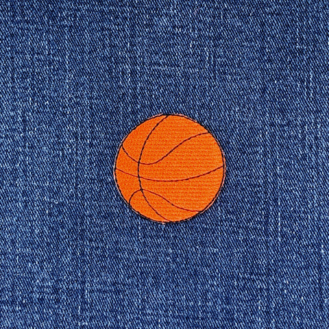 Orange basketball patch on blue denim fabric