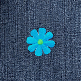 Blue flower patch on denim fabric