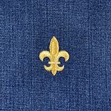 Gold fleur-de-lis patch on blue denim fabric