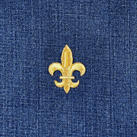 Gold fleur-de-lis patch on blue denim fabric
