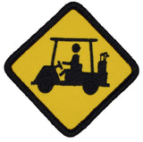 An embroidered golf course warning patch shaped like a diamond, featuring a black silhouette of a golf cart with a driver and golf clubs on a bright yellow background with a black stitched border.