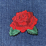 Red rose patch on denim fabric