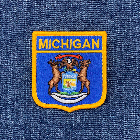 Michigan flag shield patch on a denim background