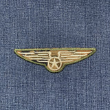 Embroidered winged star patch on denim fabric