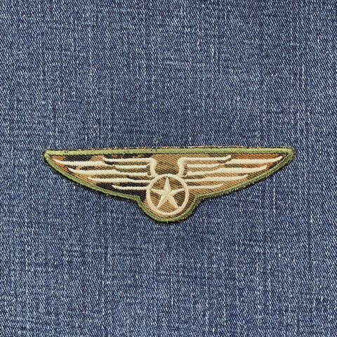 Embroidered winged star patch on denim fabric