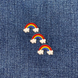 Three rainbow and cloud patches on a denim background