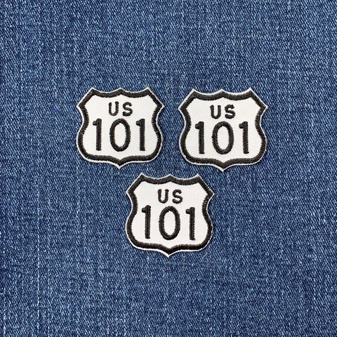 Three US Route 101 patches on a denim background