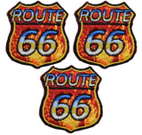 Three embroidered patches with 'ROUTE 66' text and flame designs in red, yellow, and blue colors.
