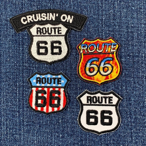 Four Route 66-themed patches on a denim background