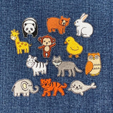 Collection of animal-themed patches on denim fabric