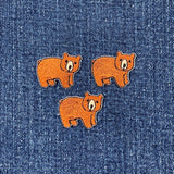 Three brown bear applique patches, designed to be ironed on, displayed on a denim fabric.