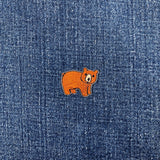 Brown bear patch on blue denim fabric