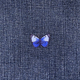 Blue butterfly patch on denim fabric