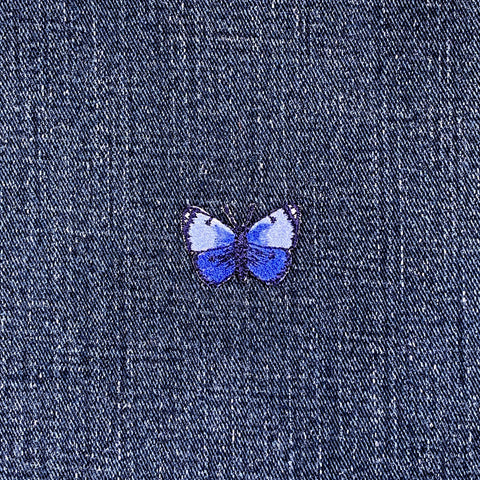 Blue butterfly patch on denim fabric