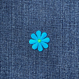 Blue flower patch on denim fabric