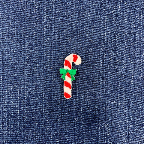 candy cane patch with a green bow on a denim background