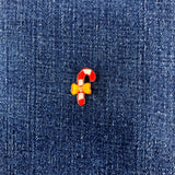 candy cane patch with a yellow bow on a denim backround