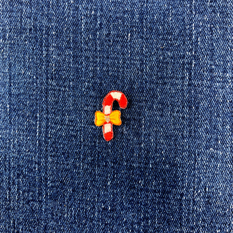 candy cane patch with a yellow bow on a denim backround