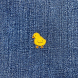 Yellow chick patch on blue denim fabric