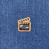 Clapperboard patch on a denim background
