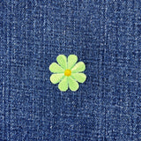 Green flower patch on blue denim fabric