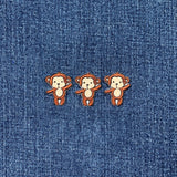 Three monkey patches on a denim background