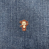 Small monkey patch on a denim fabric background