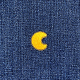 Yellow crescent moon patch on blue denim fabric