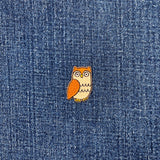 Small owl patch on a denim fabric background