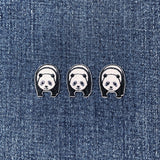 Three panda-shaped patches on a denim background