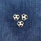 Three soccer ball patches on a denim background