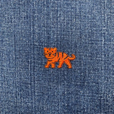 Orange tiger patch on blue denim fabric