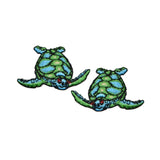 Two green sea turtle patches on a white background