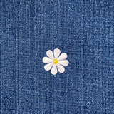 White daisy flower patch on blue denim fabric
