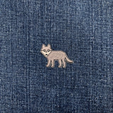 wolf-shaped patch on a denim fabric background