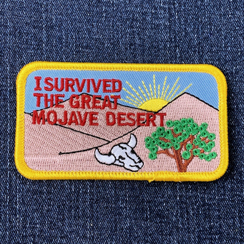 Patch with desert scene and text 'I Survived the Great Mojave Desert' on denim background